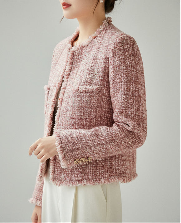 Close-up of a textured pink garment with a button on a neutral background