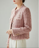 Close-up of a textured pink garment with a button on a neutral background